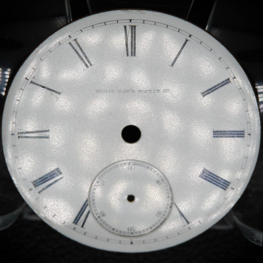 18-Size Hard Enamel Dial by the Elgin National Watch Company, showcasing the slightly diffused reflection of direct light